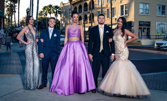 Prom Couples Posing for Picture Down Town